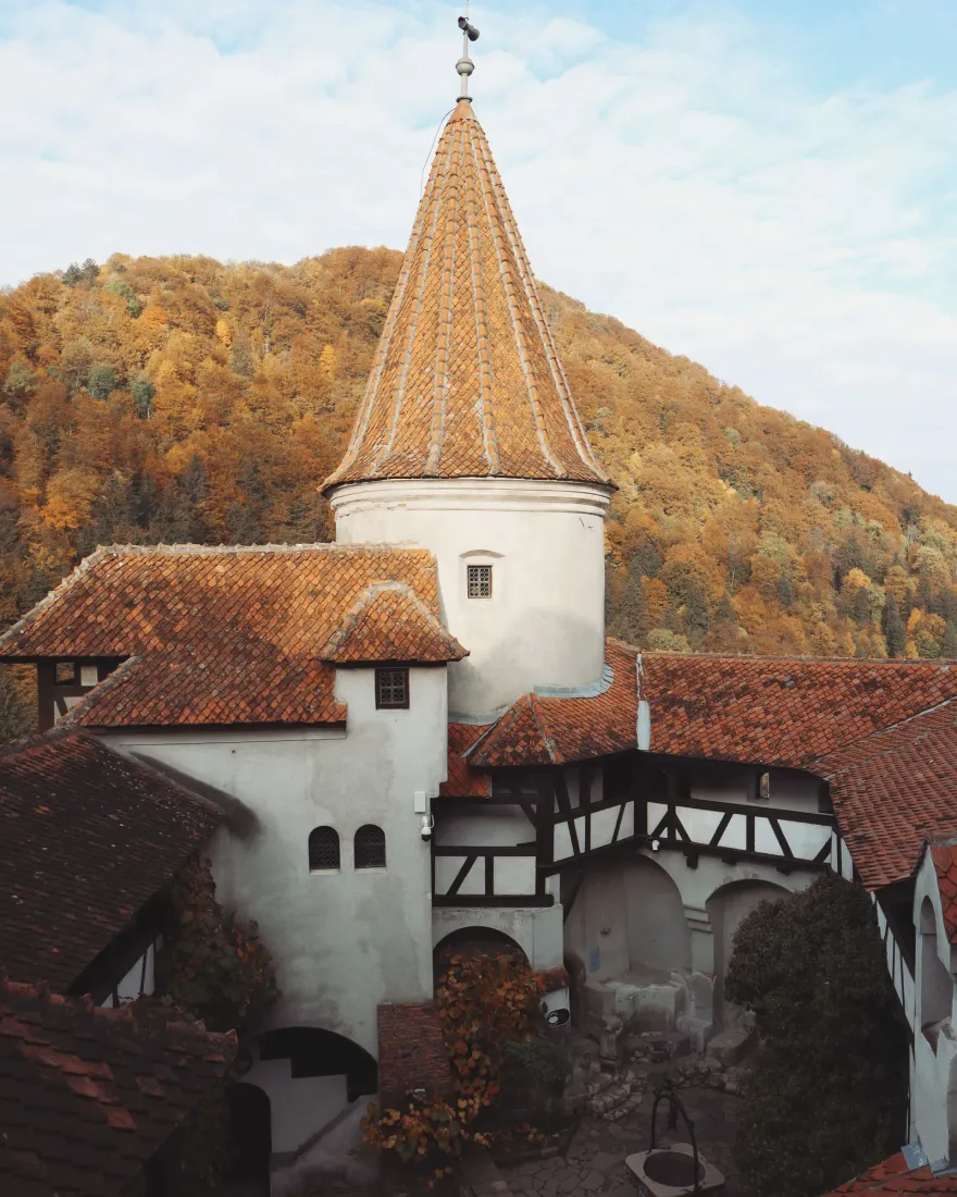 The inner courtyard of Bran Castle with its tower and tiled roofs