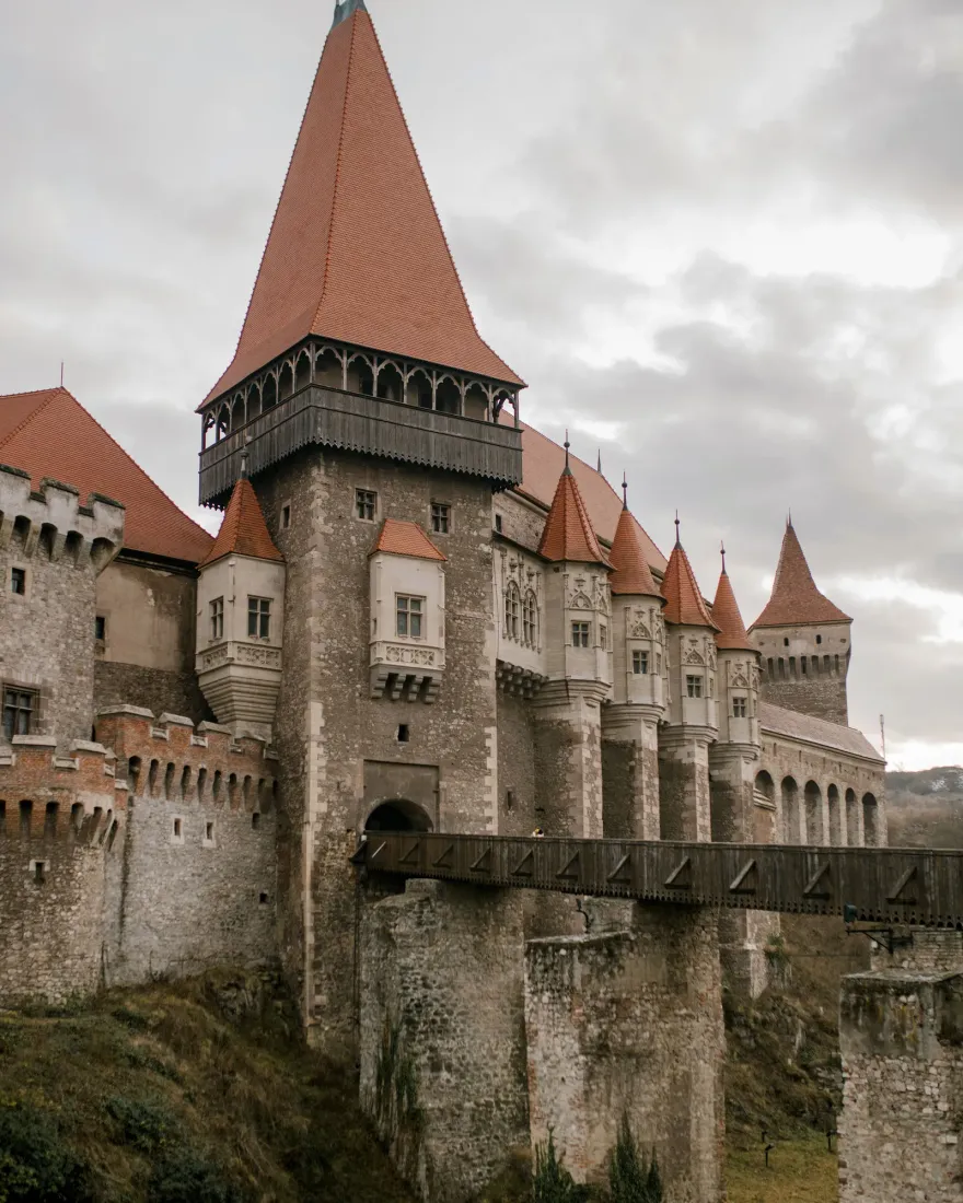 Corvin Castle and its wooden bridge over the ravine, with towers rising above the stone pillars