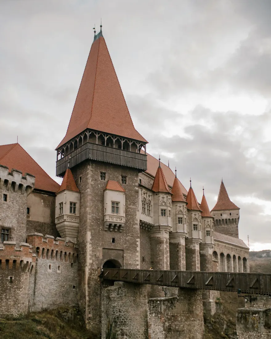 Corvin Castle in Hunedoara with its pointed towers and the bridge leading to the entrance