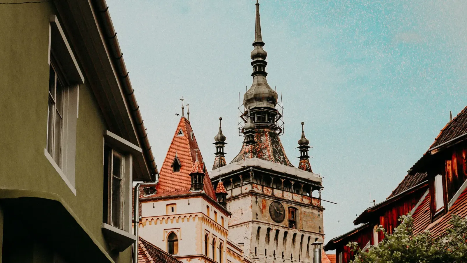 The Clock Tower of Sighișoara rising above the colourful houses of the medieval citadel