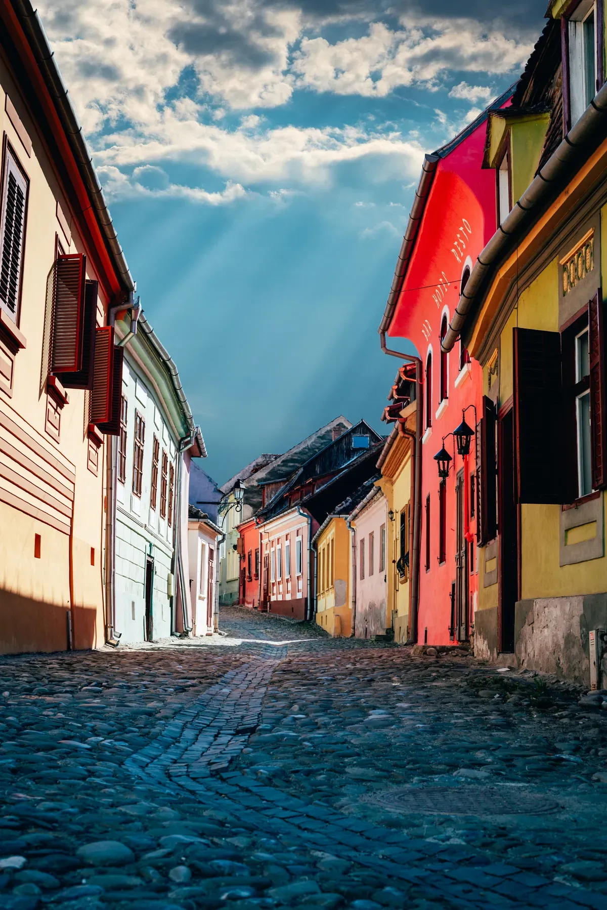 Colourful medieval houses along a cobbled street in Sighișoara