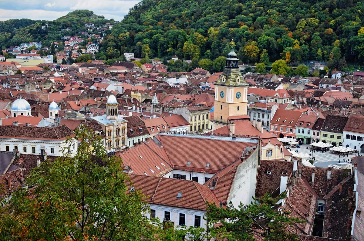 Aerial view over the red roofs of Brașov’s old town and Council Square